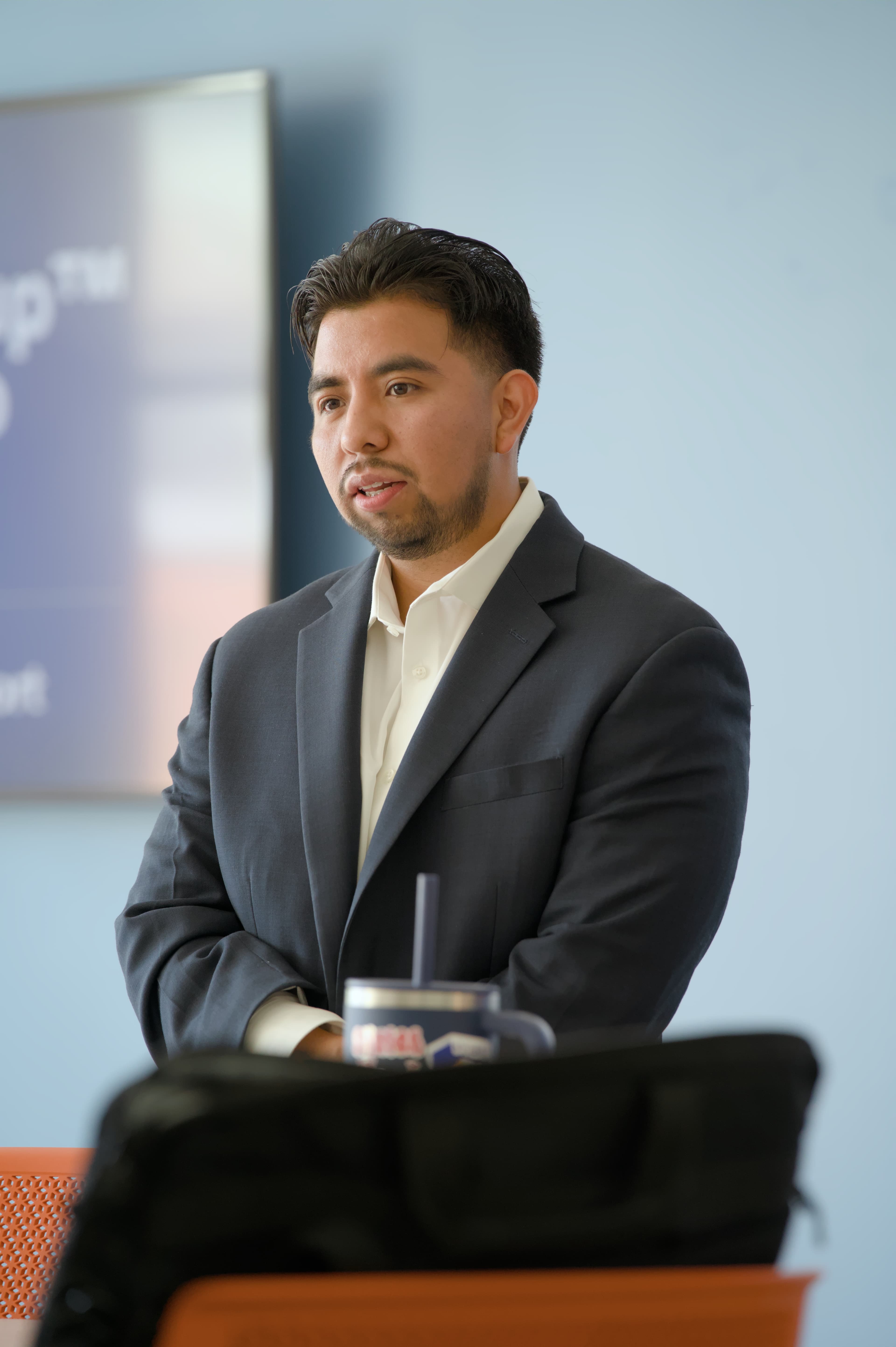 Juan Maya Hernandez speaking at a podium